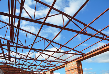 Fototapeta premium Steel Roof Trusses. Roofing Construction. Metal Roof Frame House Construction with Steel Roof Trusses Details.