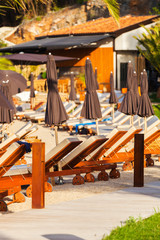 Luxury beachfront complex with sun loungers and umbrellas on the Adriatic coast. Dubrovnik, Croatia.
