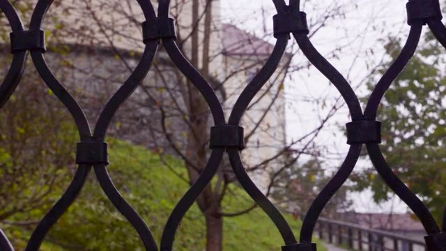 Slovenia. Castle in the park through the grating fence