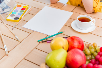 Young school gilr drawing pictures at home