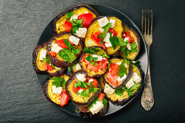 Appetizers - grilled eggplants with garlic, feta cheese and tomatoes.