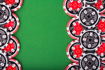 top view of green casino table with red and black chips