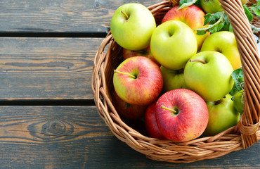3 Different kinds of apples and the tasty benefits of each.
colorful and various kinds of apples in the basket on wooden background.