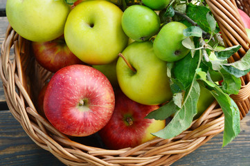 3 Different kinds of apples and the tasty benefits of each.
colorful and various kinds of apples in the basket on wooden background.