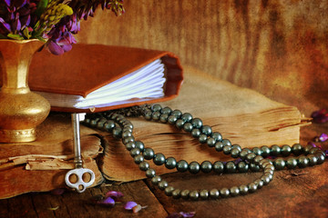 Quran and flower on wooden table