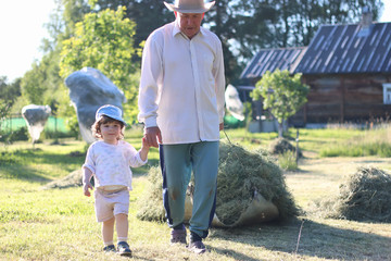 child and grandfather harvested hay