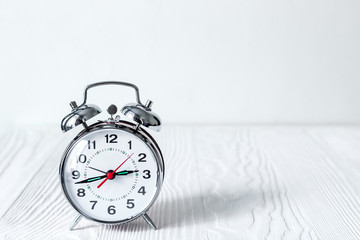 alarm clock at empty locker on white background