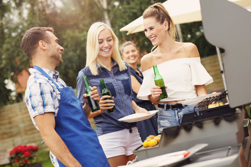 Group of friends having barbecue party