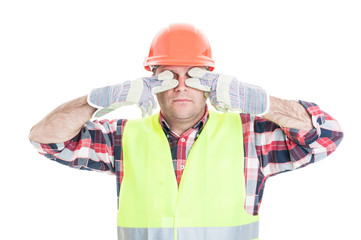 Male builder making the see no evil gesture
