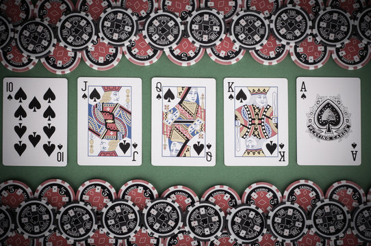 top view of green casino table with royal flush, red and black c
