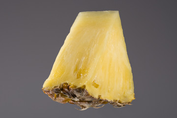 Pineaple portion on gray, studio shoot