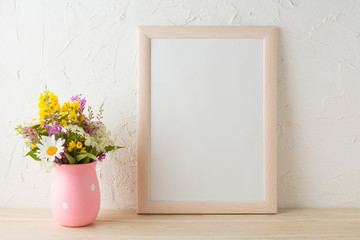 Frame mockup with wild flowers in pink vase