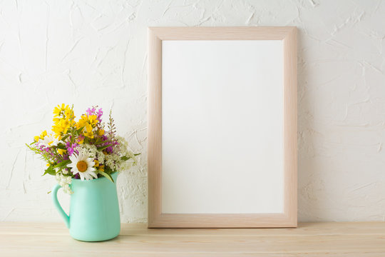 Frame mockup with flowers in mint green vase