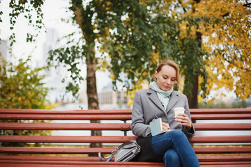 Fototapeta premium Trendy woman in stylish coat sitting