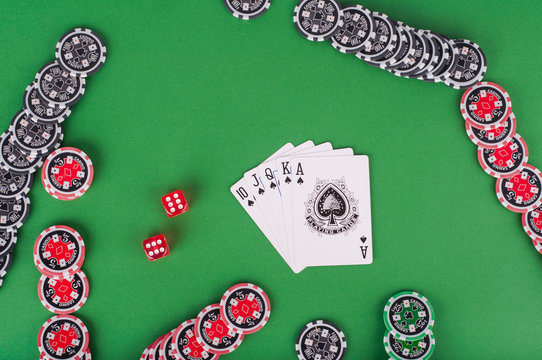 top view of green casino table with royal flush, red and black c