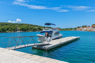 Small boat anchored in the Prvic Luka port at beautiful summer day in Croatia.