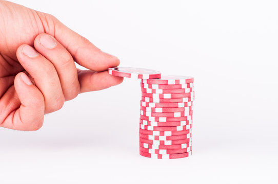 Human Hand Takeing Red Casino Chips Isolated On White