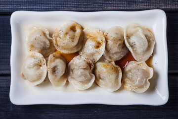 hot dumplings with soy sauce in the dish on the table top view