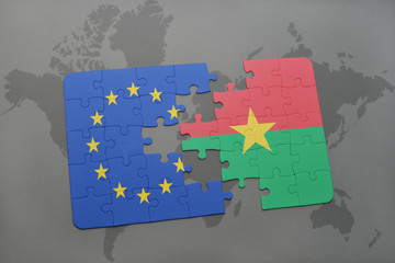puzzle with the national flag of european union and burkina faso on a world map background.