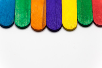 Colorful popsicle sticks over white background with copy space