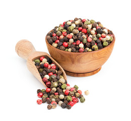 peppercorn mix in a wooden bowl isolated on white
