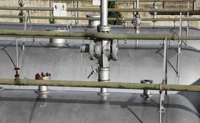 giant shut-off valve and piping above the pressure vessel of a p