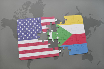 puzzle with the national flag of united states of america and comoros on a world map background.