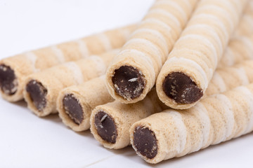 Chocolate wafer cream rolls isolated over white background