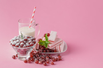Milk glass and dusted powdered sugar with cherries and mint