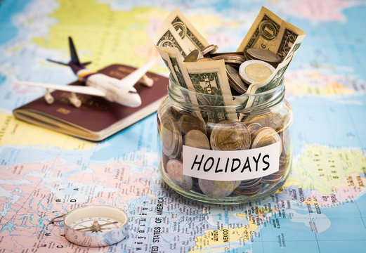 Holidays budget concept with compass, passport and aircraft toy