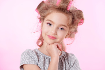 Obraz na płótnie Canvas Little pretty girl in hair curlers 