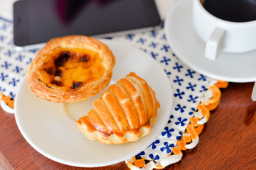 Cake with phone on table, top view