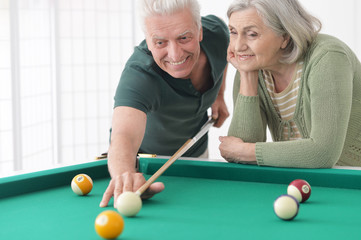old couple playing billiard