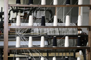 Fototapeta na wymiar spools of thread to spin in the old industrial weaving loom fabr