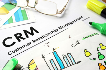 Paper with words CRM customer relationship management.