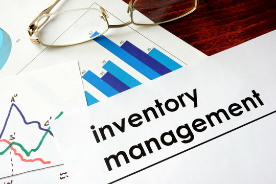 Paper with words inventory management and charts.
