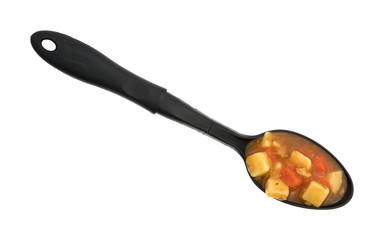 Manhattan style clam chowder on large spoon atop a white background.