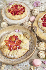 Set of rustic fruit tarts and meringues, homemade pastry.
