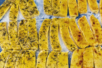 raw salted cheese puff sticks with pepper and Provencal herbs