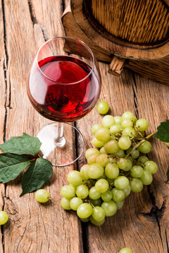 Wine and cheese on wooden table with fresh grapes 