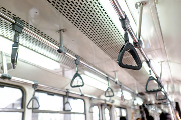 hanging straps or grab handles on a metro train
