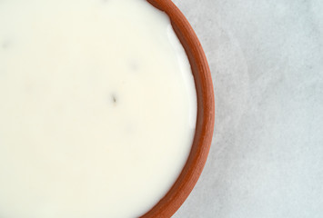 Fat-free blue cheese dressing in a small bowl on a gray marble cutting board top close view.