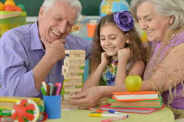 Grandparents with granddaughter playing together