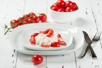Cherry Tomatoes, Soft Cottage Cheese. White Table.