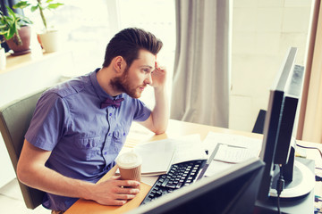 Fototapeta na wymiar creative male worker with computer drinking coffee