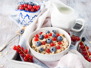 Oatmeal porridge with blueberries and red currants