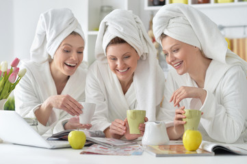 Obraz na płótnie Canvas women wearing a white bathrobes with laptop