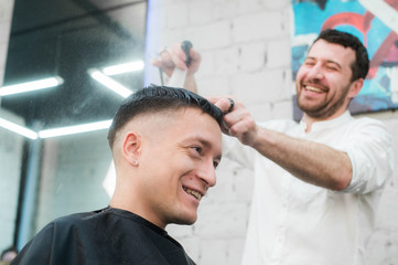 Male Barber Giving Client Haircut In Shop