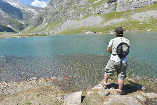 Flyfisherman fishing in mountain lake