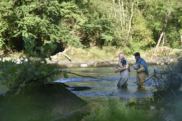 Flyfisherman with fishing guide in river